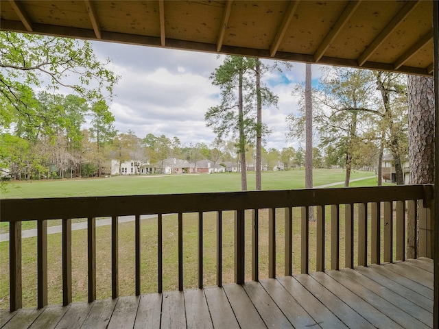 wooden terrace with a lawn