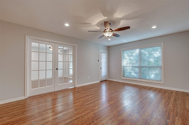 spare room with ceiling fan, french doors, a textured ceiling, and wood finished floors