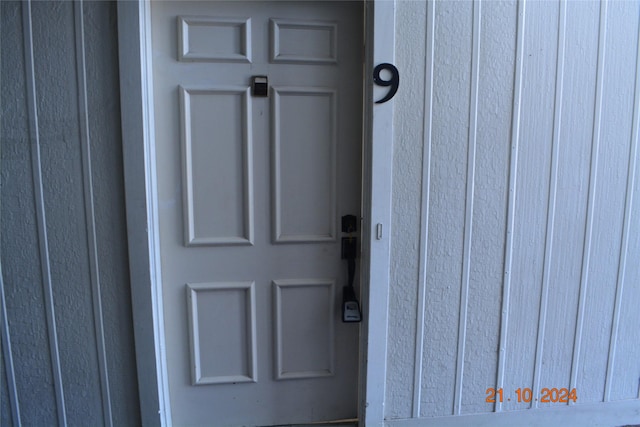 view of exterior entry with board and batten siding