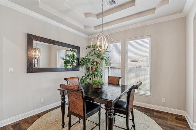 dining area with a healthy amount of sunlight, visible vents, a chandelier, and a raised ceiling