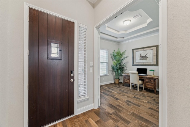 foyer with dark wood-style floors, baseboards, visible vents, and a tray ceiling