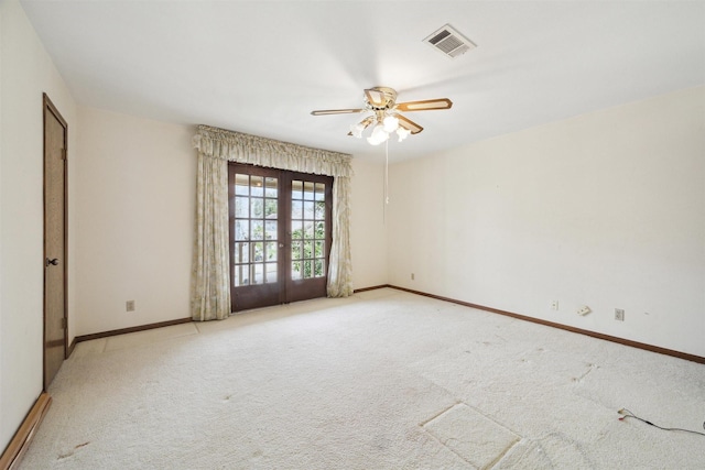 spare room featuring baseboards, visible vents, a ceiling fan, french doors, and carpet floors