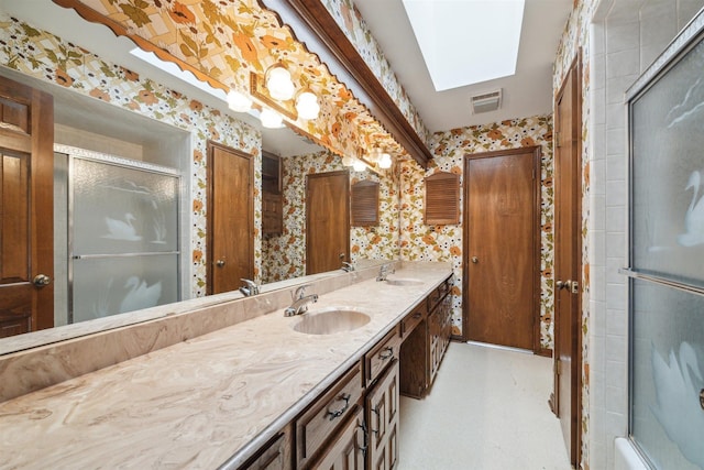 full bathroom featuring wallpapered walls, visible vents, a sink, and a shower with shower door