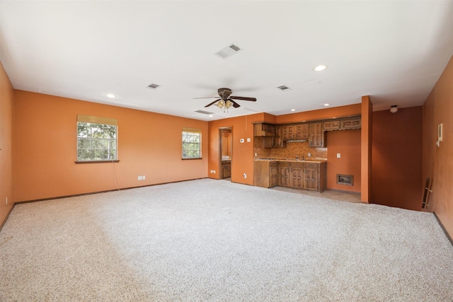 unfurnished living room with light carpet, visible vents, a ceiling fan, and recessed lighting