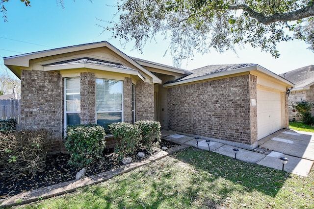 single story home with an attached garage and brick siding