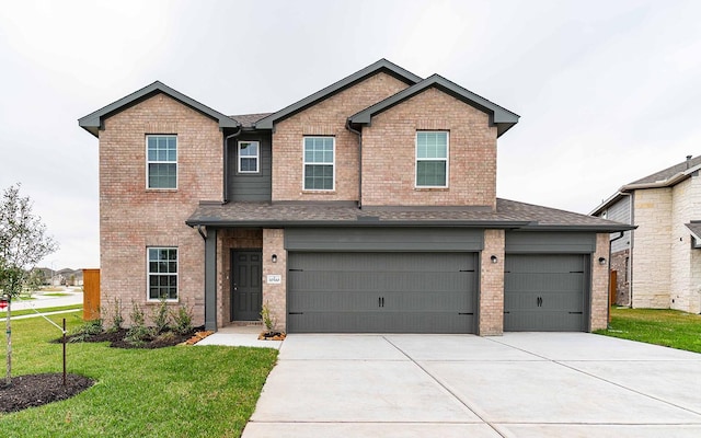 view of front of home featuring driveway, a garage, a shingled roof, a front lawn, and brick siding