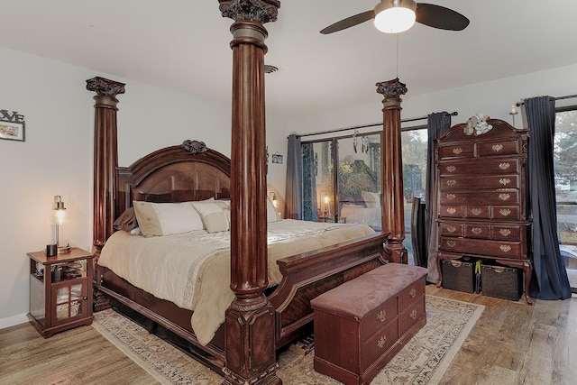 bedroom with ceiling fan, light wood finished floors, decorative columns, and baseboards