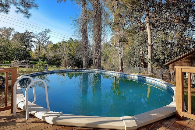 pool featuring a deck and fence