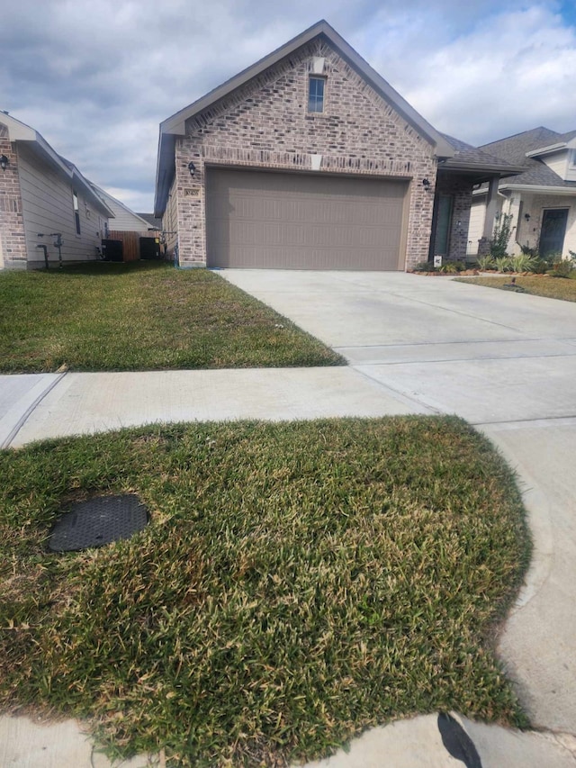 view of front of house featuring driveway, brick siding, a front lawn, and an attached garage