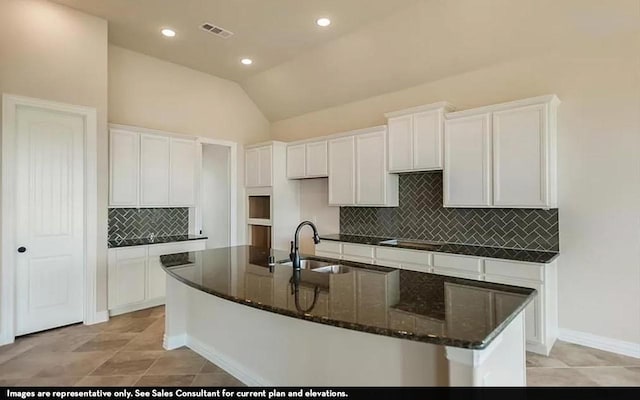 719 Woodbinde Dr, League City, TX 77573 - kitchen with white cabinetry, a center island with sink, visible vents, and a sink