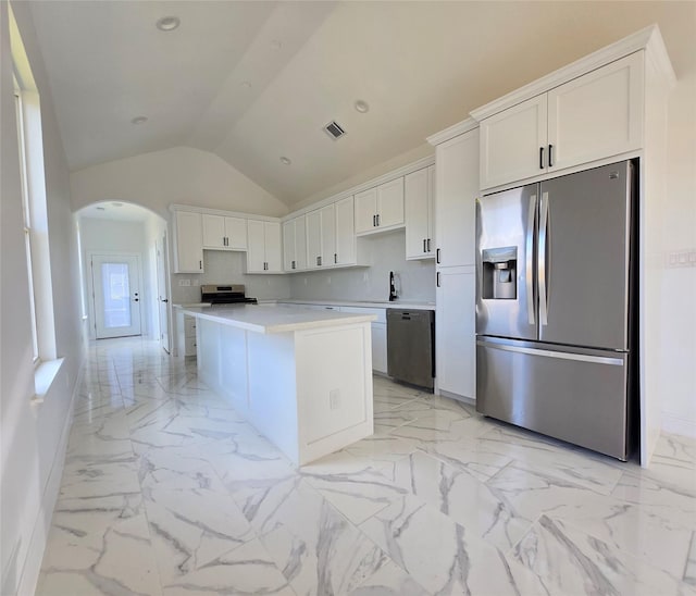 kitchen featuring a center island, marble finish floor, stainless steel appliances, light countertops, and white cabinetry