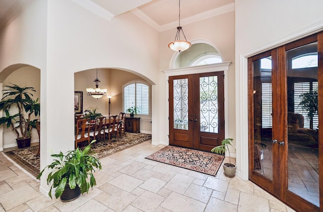 foyer featuring stone tile floors and french doors