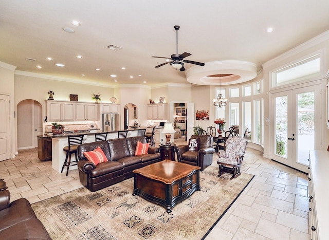 living room with arched walkways, visible vents, stone tile floors, and recessed lighting