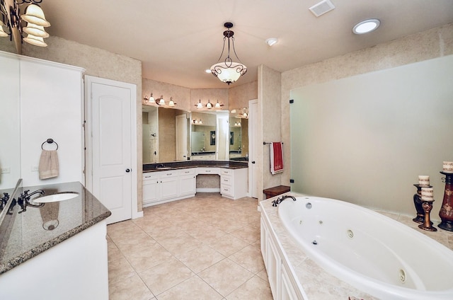 full bath featuring a whirlpool tub, tile patterned flooring, visible vents, and vanity