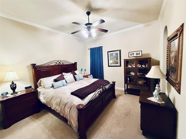 bedroom with ornamental molding, light carpet, and a ceiling fan