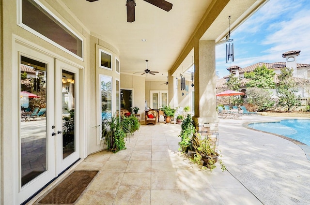 view of patio with ceiling fan, french doors, and a fenced in pool