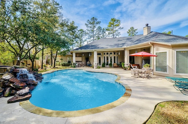 view of swimming pool featuring fence, a fenced in pool, and a patio