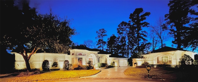 mediterranean / spanish home featuring driveway and an attached garage