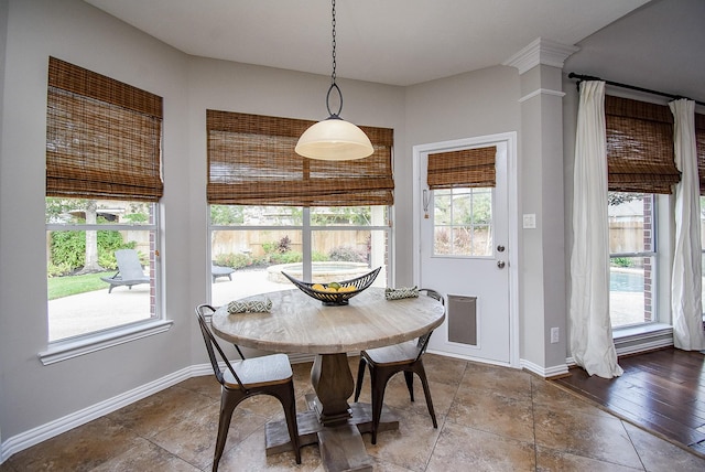 dining room featuring a healthy amount of sunlight and baseboards