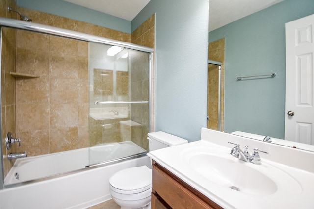 full bathroom featuring toilet, bath / shower combo with glass door, and vanity