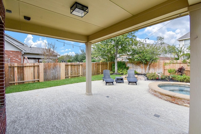 view of patio featuring a fenced backyard and an outdoor hot tub