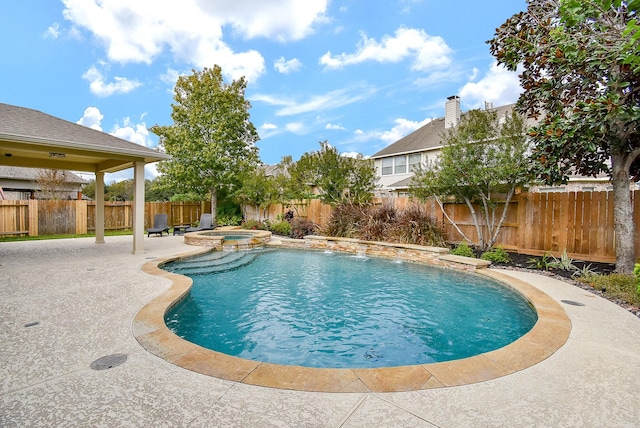 view of pool with a patio area, a fenced backyard, and a pool with connected hot tub