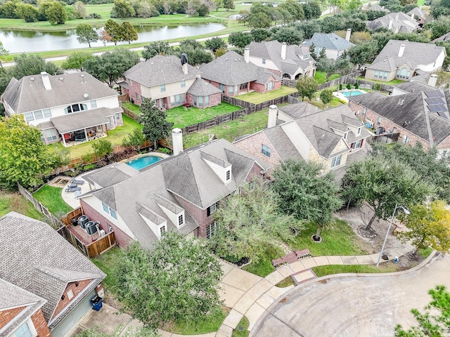 drone / aerial view with a water view and a residential view