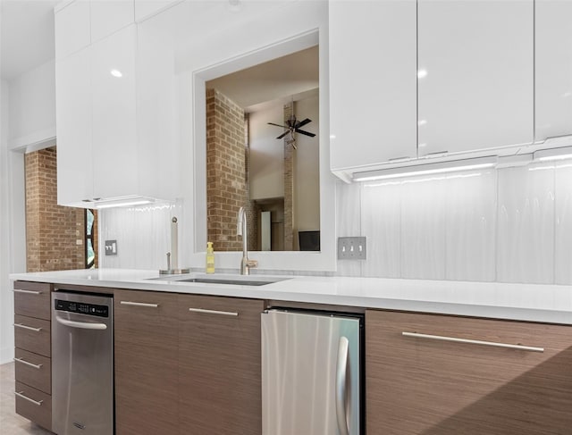 kitchen featuring modern cabinets, white cabinetry, light countertops, and a sink