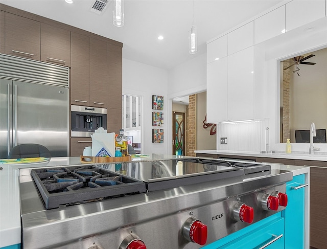 kitchen featuring visible vents, white cabinets, modern cabinets, hanging light fixtures, and light countertops