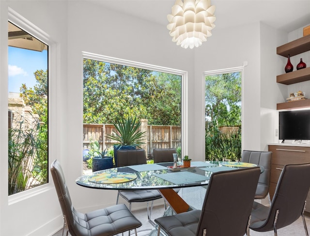 dining space with a chandelier and a healthy amount of sunlight