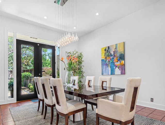 tiled dining room with recessed lighting, french doors, and baseboards