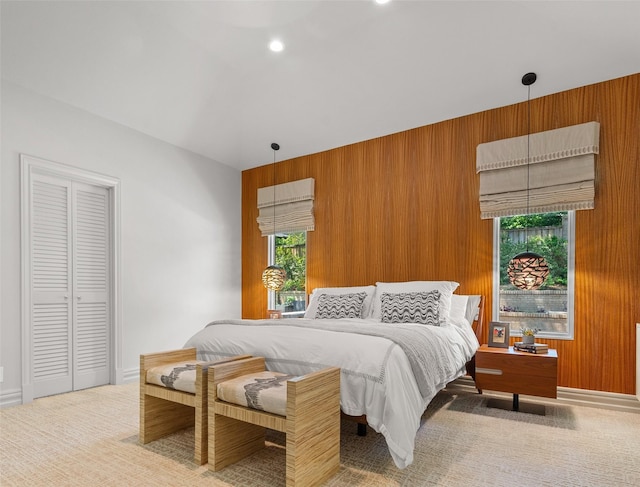 bedroom featuring wood walls and carpet flooring