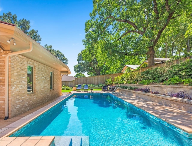 view of swimming pool with a fenced in pool and a fenced backyard