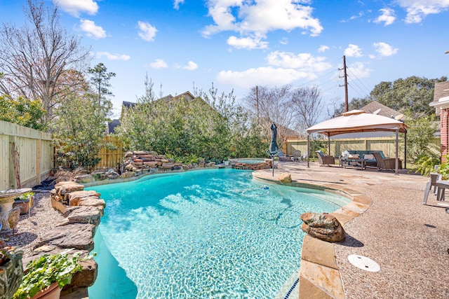 view of pool with a fenced in pool, a gazebo, a patio area, an in ground hot tub, and a fenced backyard