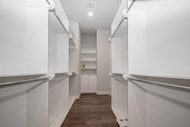 walk in closet with visible vents and dark wood finished floors