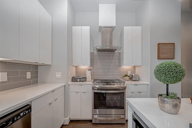 kitchen with appliances with stainless steel finishes, light countertops, and exhaust hood