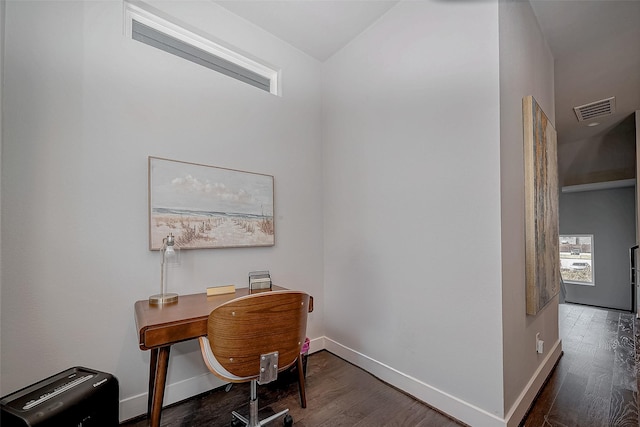 office area with dark wood-style floors, visible vents, and baseboards