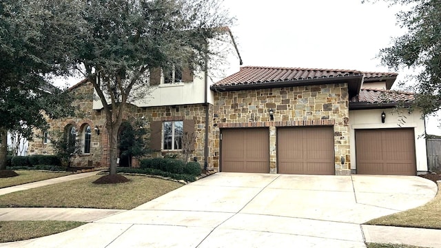 view of front of property featuring a garage, stone siding, a tile roof, and driveway