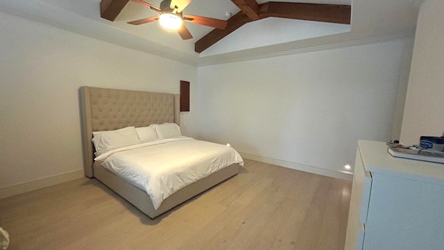 bedroom featuring vaulted ceiling with beams, ceiling fan, wood finished floors, and baseboards