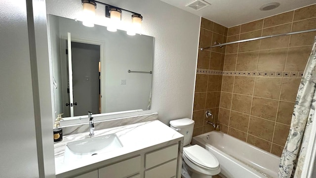 full bath featuring a textured wall, toilet, vanity, visible vents, and shower / bath combo with shower curtain