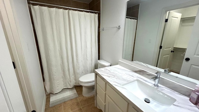 full bath with vanity, toilet, and tile patterned floors