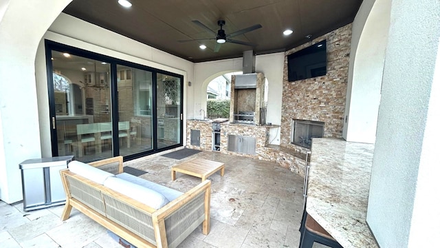 view of patio / terrace with a ceiling fan, a sink, and area for grilling