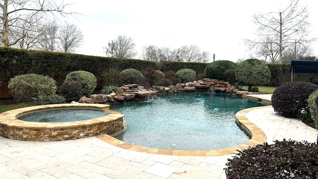 view of swimming pool with a pool with connected hot tub and a patio