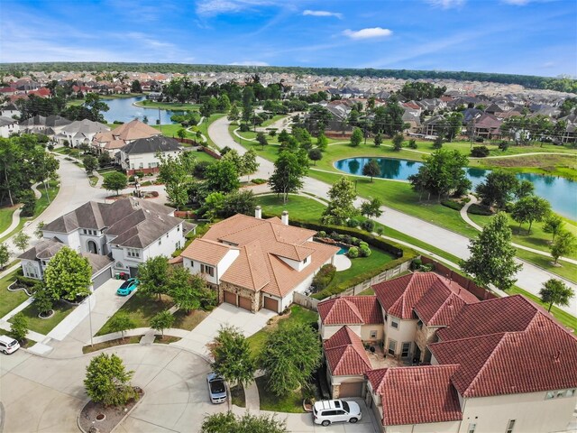 drone / aerial view featuring a water view and a residential view