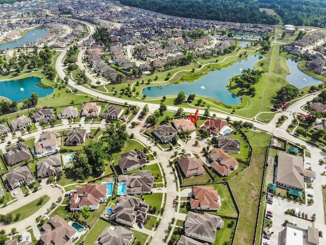 drone / aerial view with a water view and a residential view