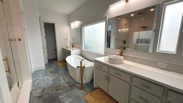 bathroom featuring a freestanding bath, marble finish floor, a shower stall, and vanity