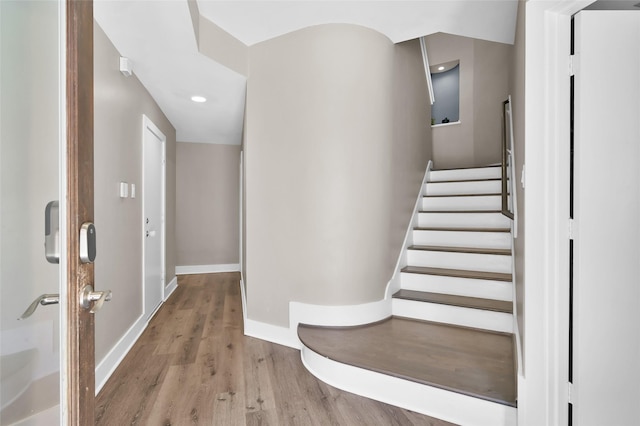 stairs featuring baseboards and wood finished floors