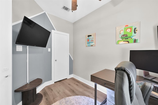 office space with light wood-style floors, visible vents, baseboards, and a ceiling fan