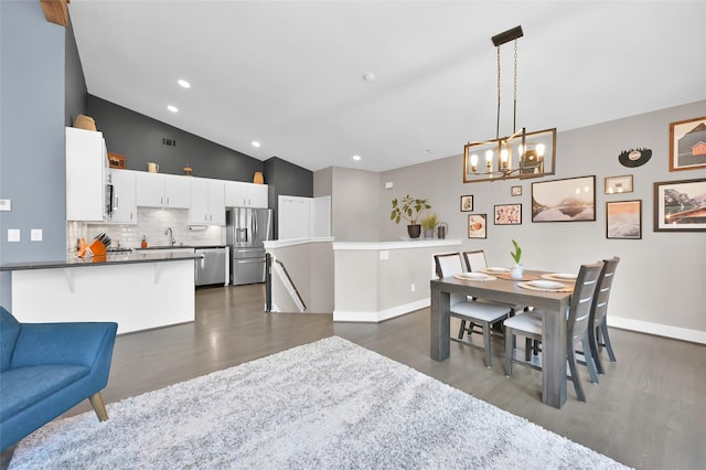 dining space featuring baseboards, vaulted ceiling, dark wood-type flooring, and recessed lighting