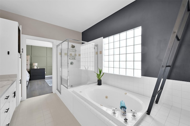 full bathroom with a stall shower, tile patterned flooring, vanity, and a whirlpool tub